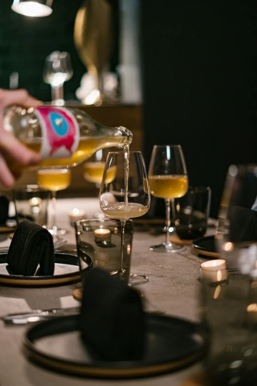 plates with glasses and bottles of wine on a table