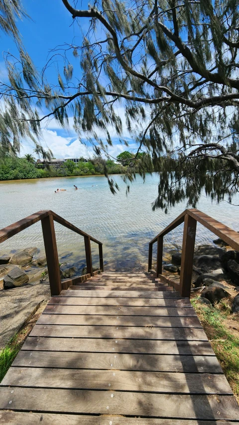 there are two wooden bridge leading to water