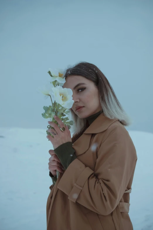 a woman with long hair and flowers in her hands