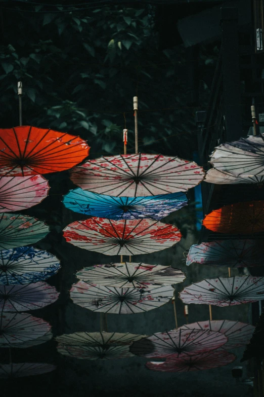 colorful umbrellas sitting in the middle of some water