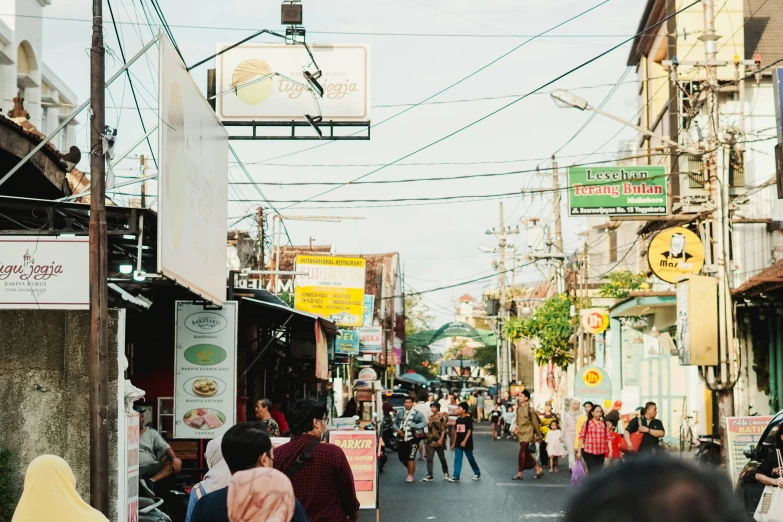 people walk in a crowded street in the daytime