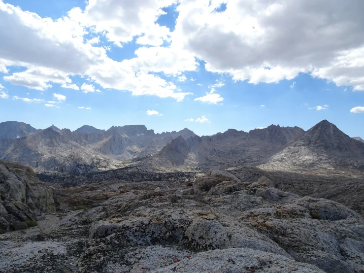 many rocks on the ground with a cloudy sky