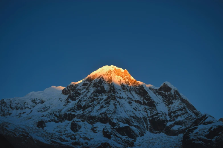 the top of the mountain is covered in snow