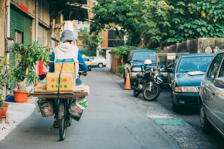 a person with a box is riding a motorcycle