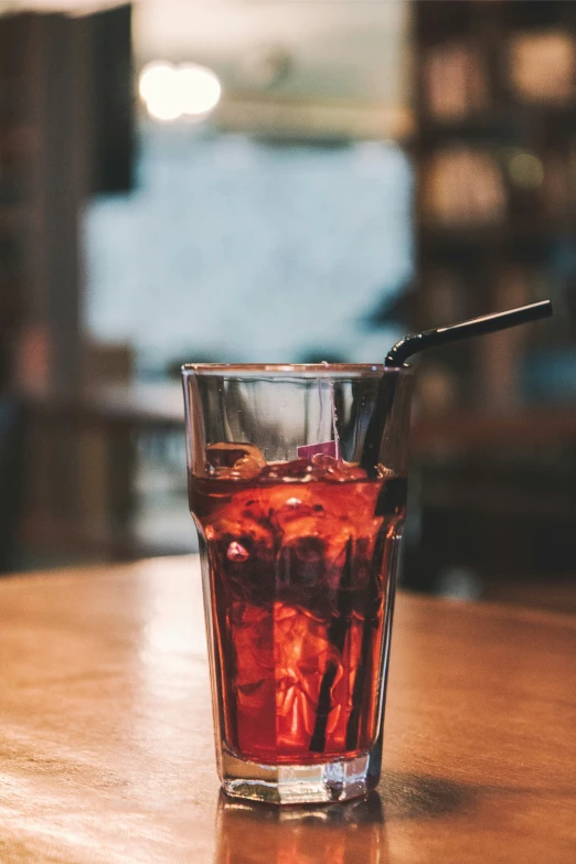 a glass filled with liquid sitting on top of a table