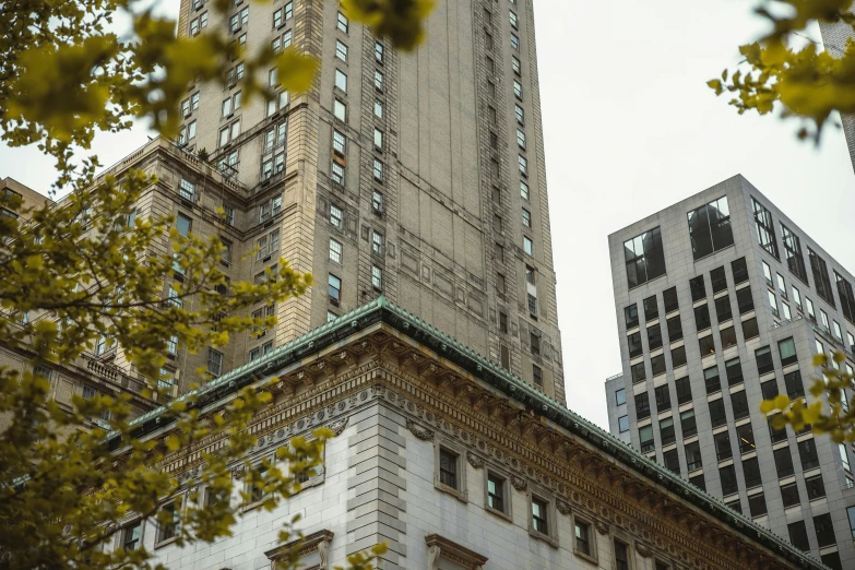 there is a tall building between two large buildings