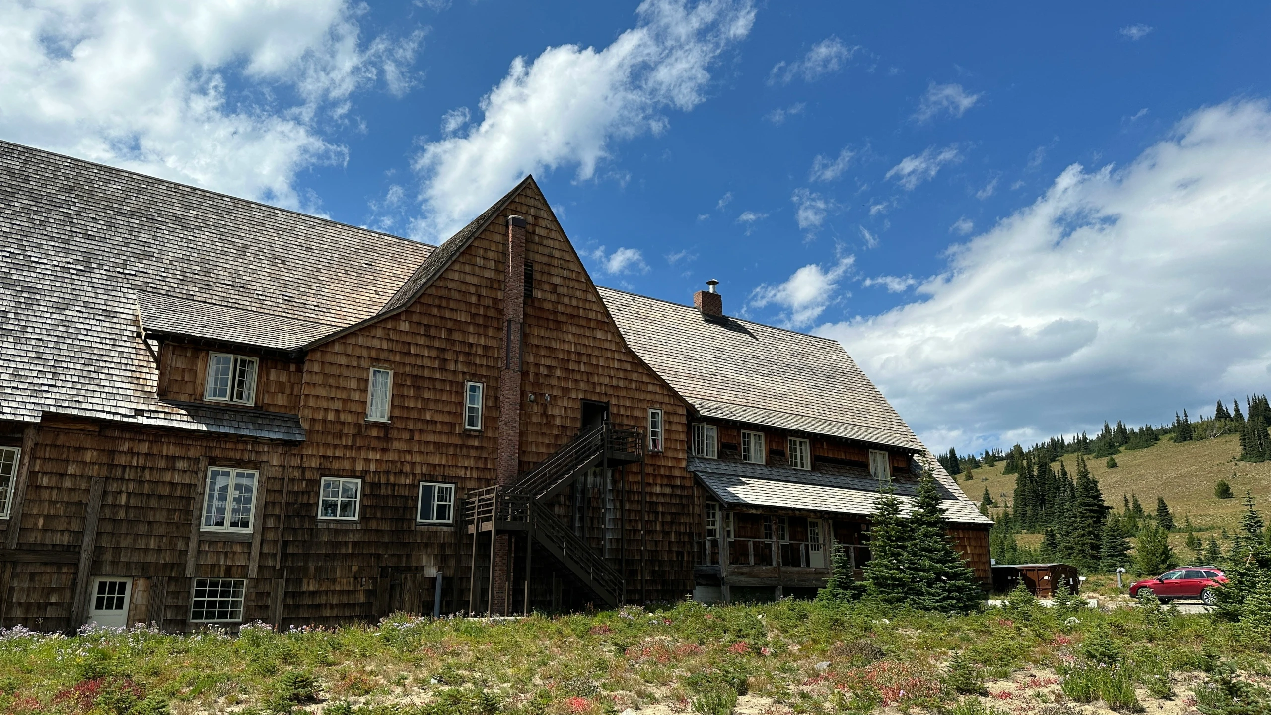 a large building in the field with a lot of windows