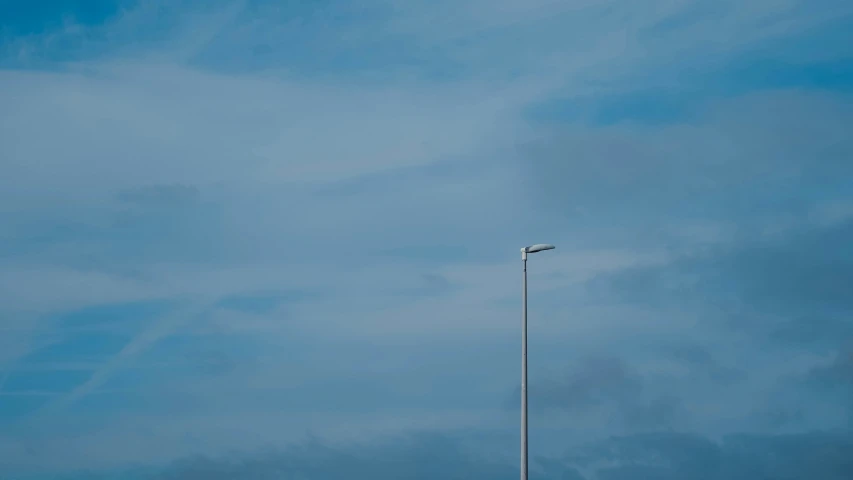 a plane flying through the air on a cloudy day