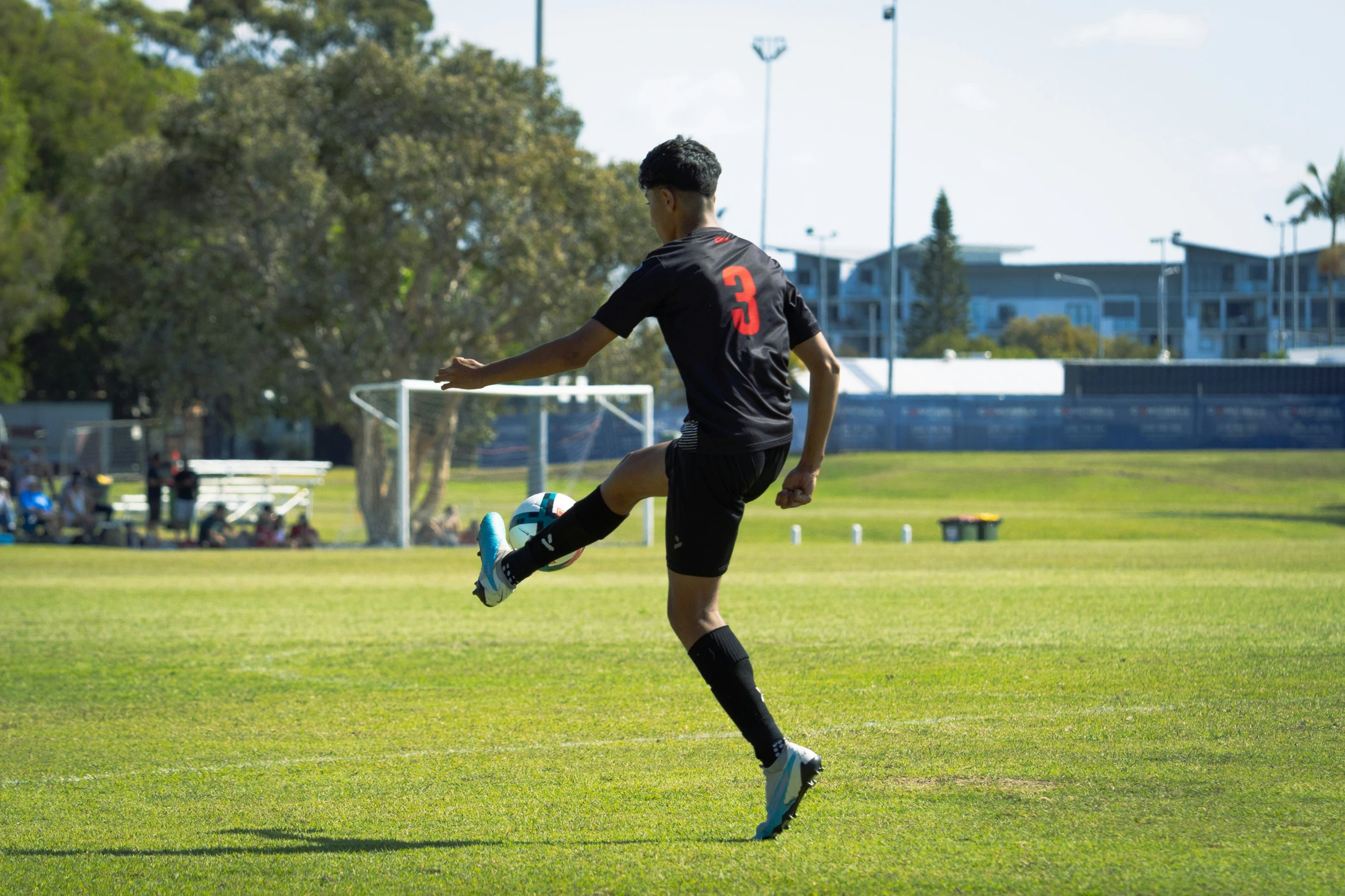 a soccer player that has just finished a soccer kick