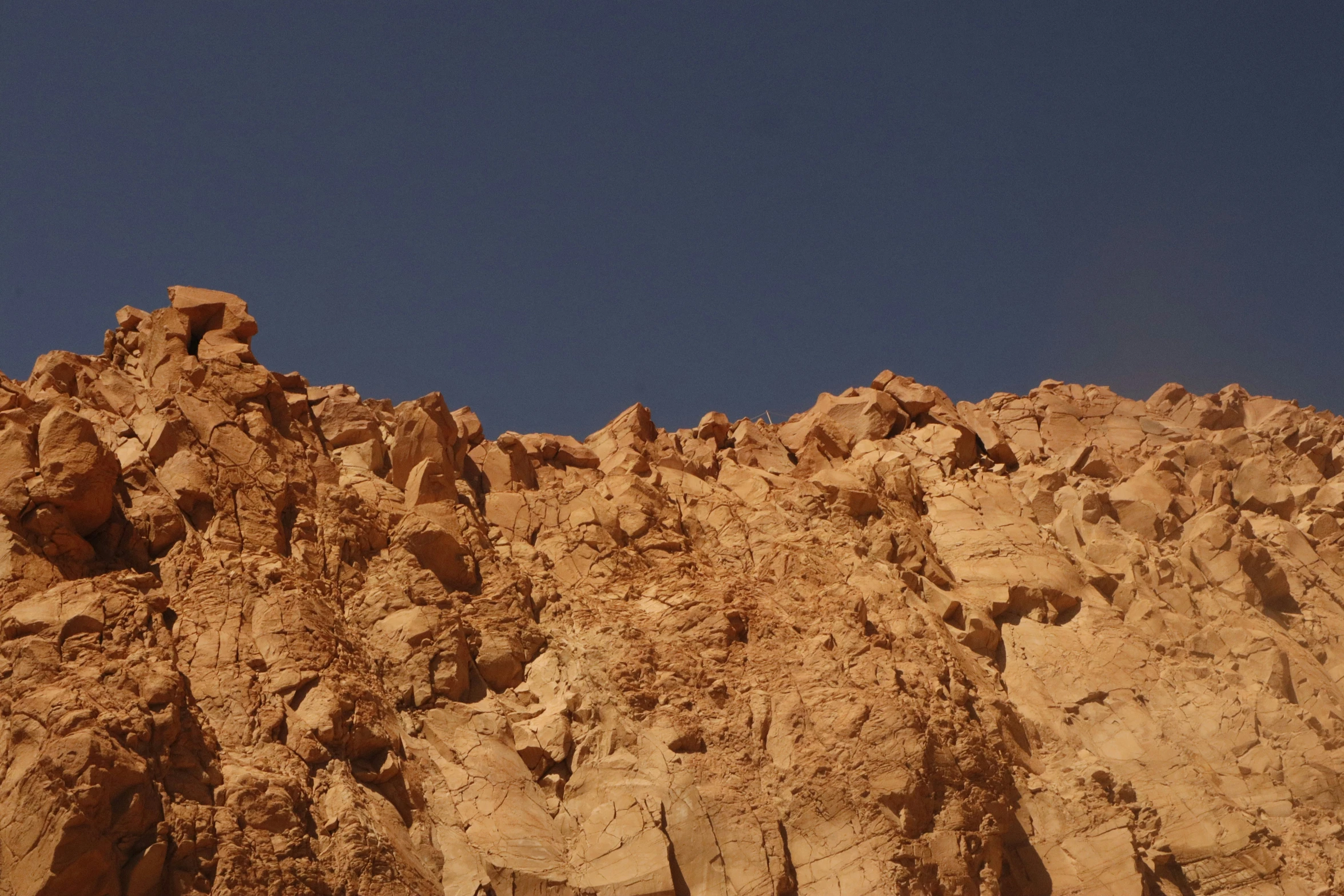 a mountain of rock against a blue sky