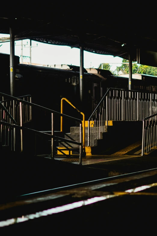 a platform at a train station with stairs leading up