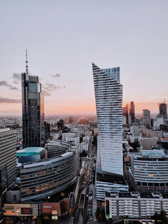 a city with a lot of tall buildings and a building in the middle