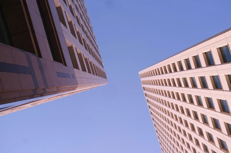 looking up at two tall buildings in the city