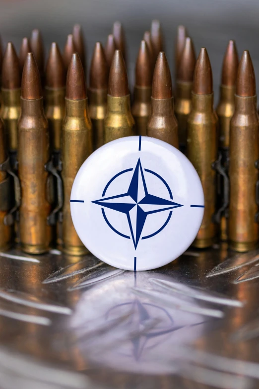 a compass logo on a white and blue on surrounded by many ss bullet shells