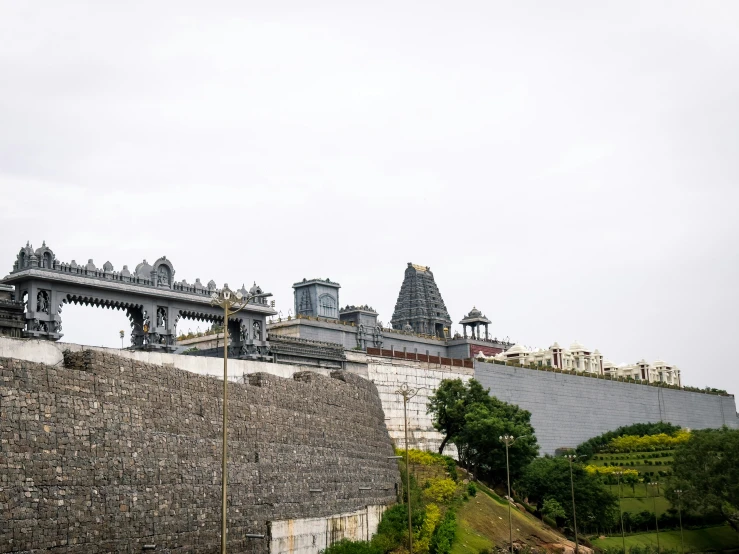 an elaborate building with spires and a long walkway below