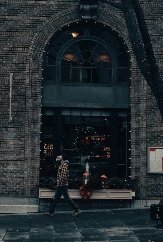 man with suitcase walking in front of building in urban setting