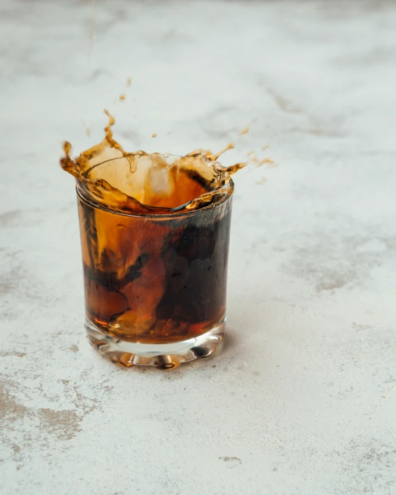 an iced drink with ice sitting on the ground