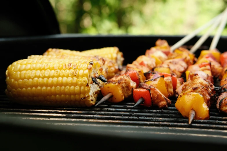 a corn on the cob with toothpicks and  pepper