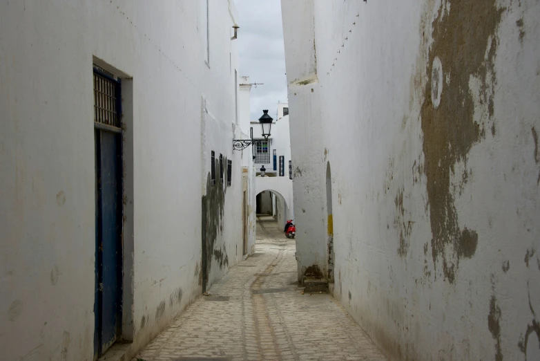 two narrow alleys with an arch leading to a clock