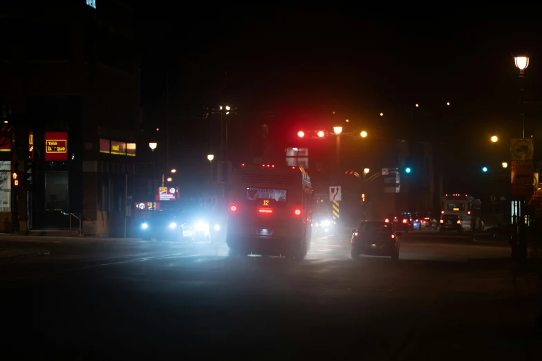 a large truck driving down a street at night