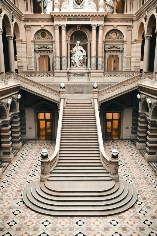 staircase in large building with patterned steps leading to windows