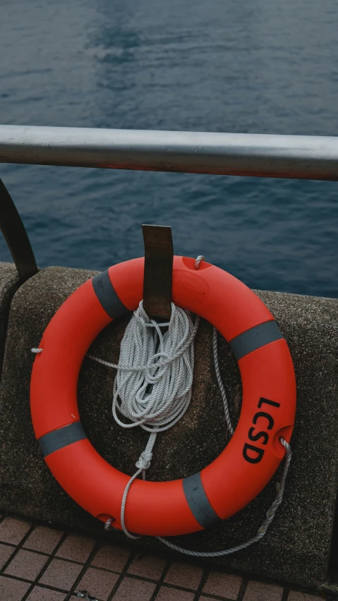 life preserver with rope and a rope reel in the foreground