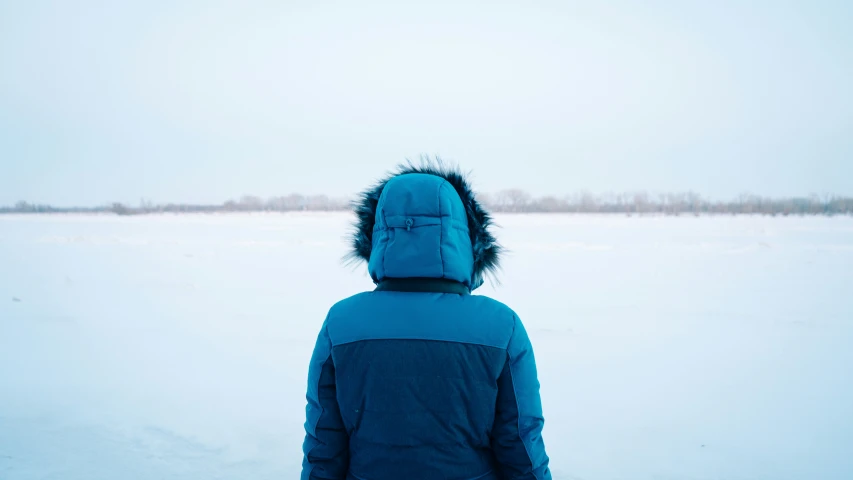 someone wearing a coat in the snow outside