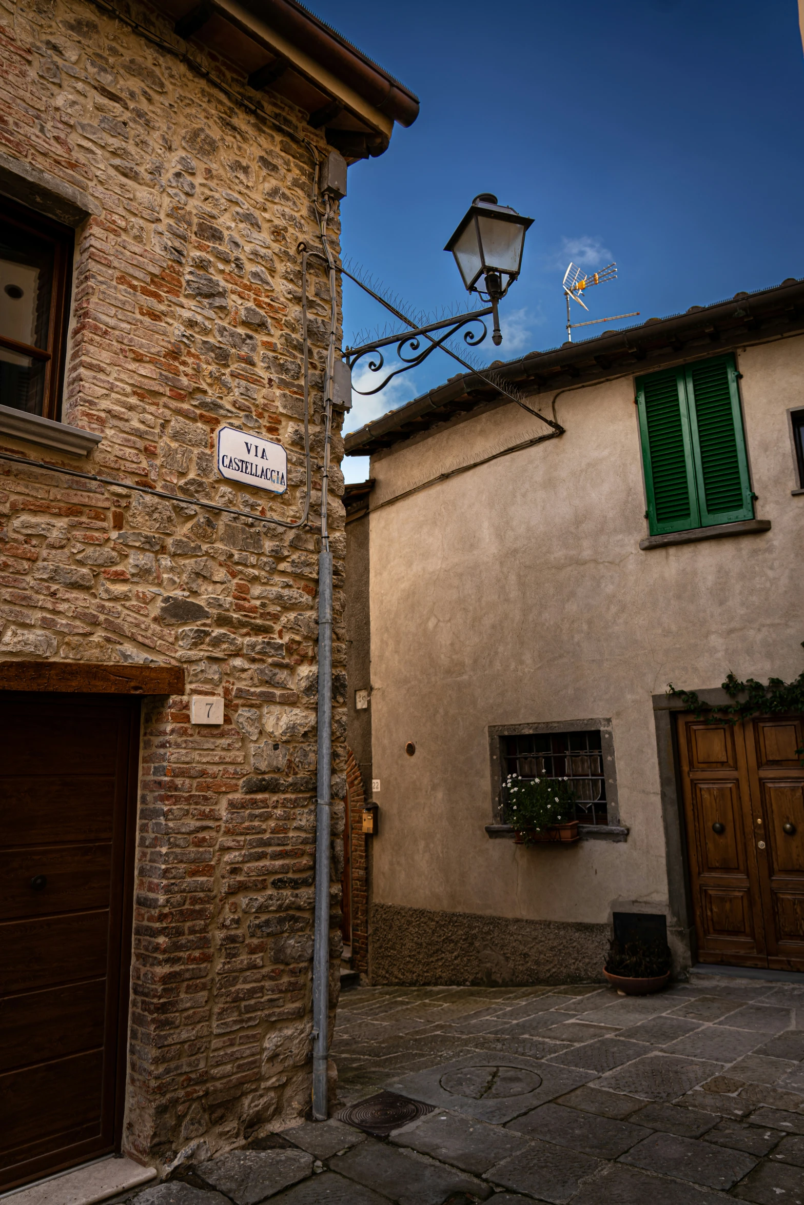 a couple of doors and a street sign on a pole