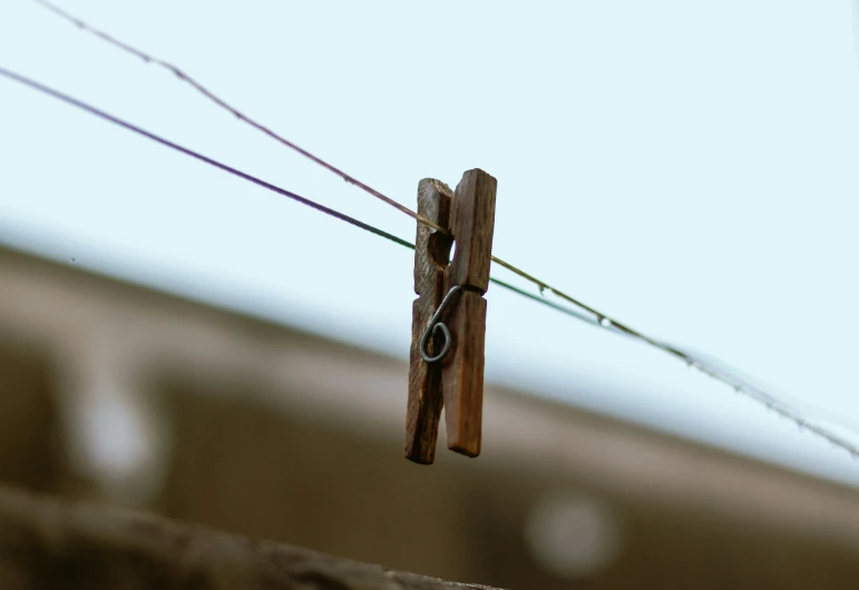 clothes pins on a wire outside of a house