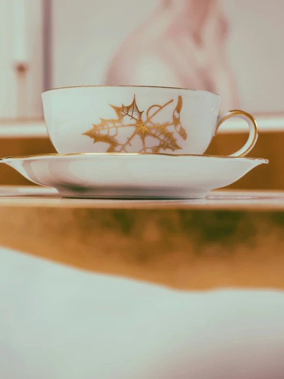 this is an antique china coffee cup with gold detailing