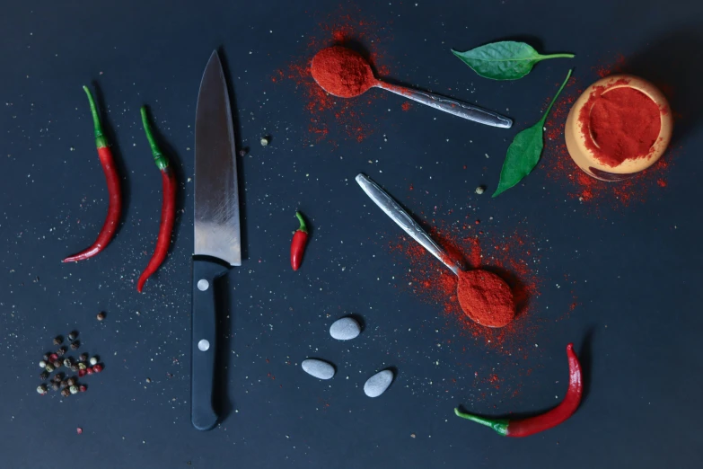 red and green peppers with a knife and a spoon