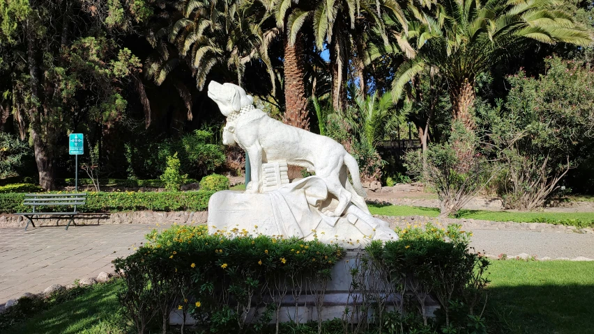 an intricate marble statue stands in front of some trees