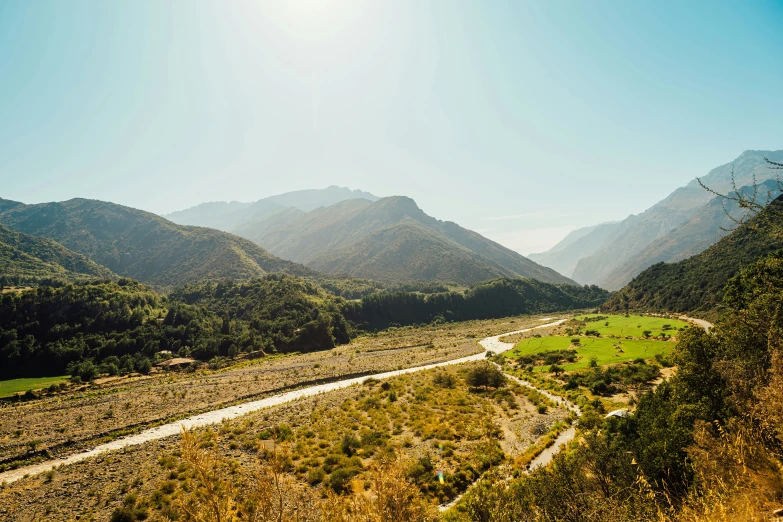 the view of a valley and some mountains