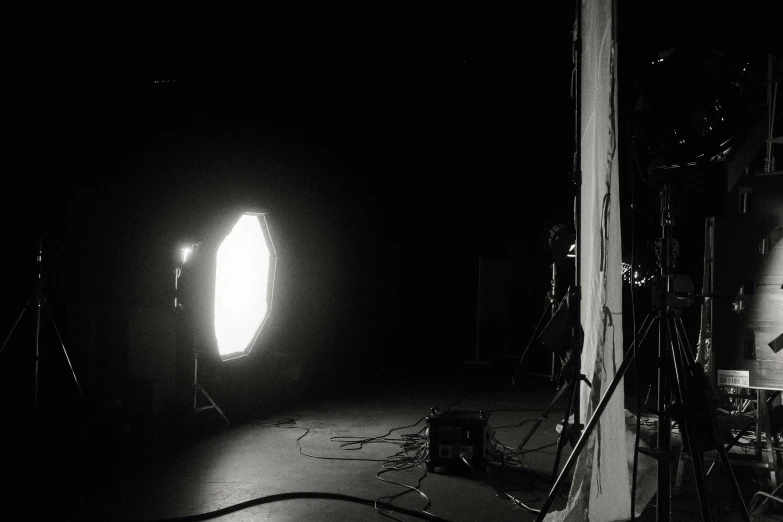 a darkened room with spotlights and drums in the background