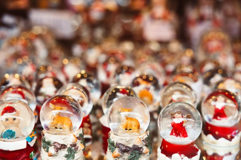 various glass bowls containing christmas ornaments and small figures
