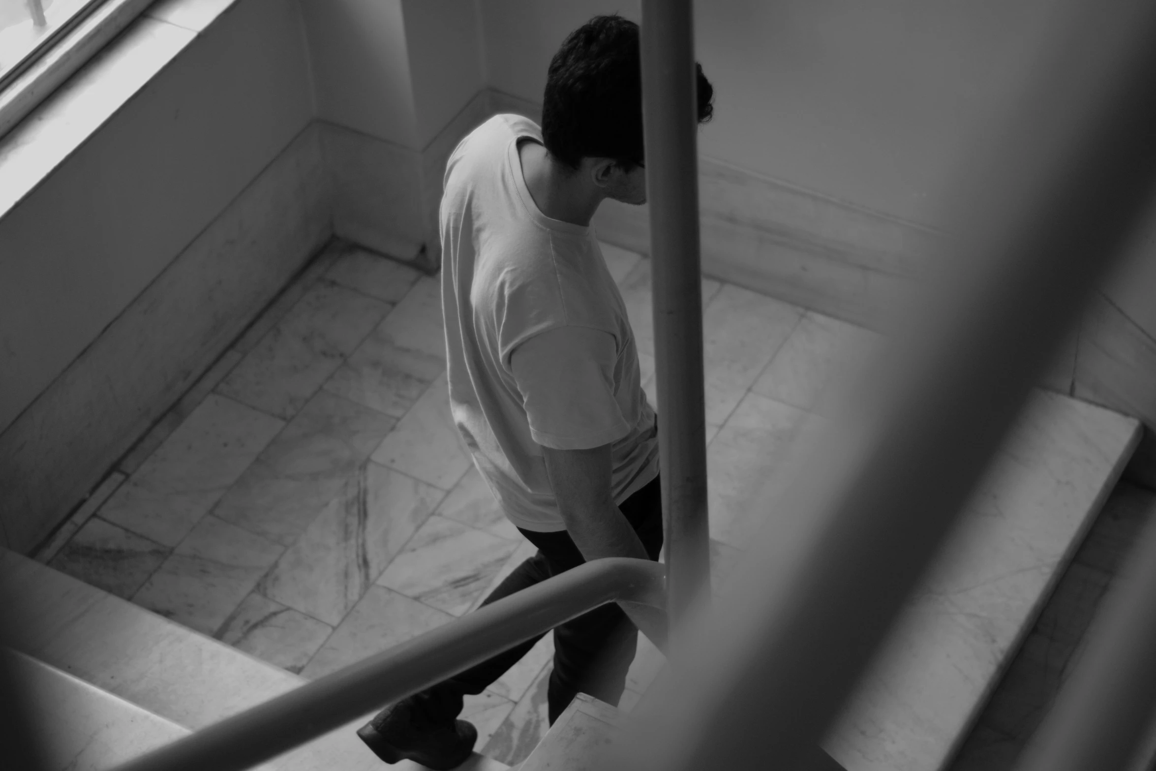 young man walking up the stairs, with his feet on the ground