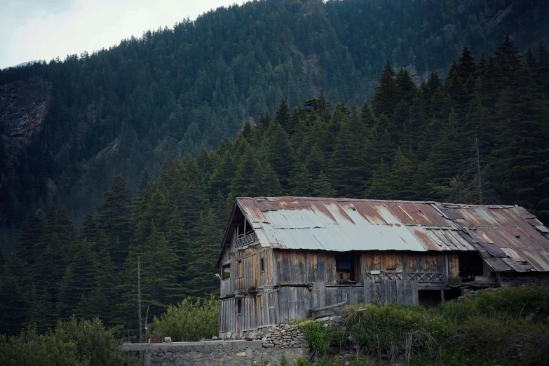 an old run down house on a hillside