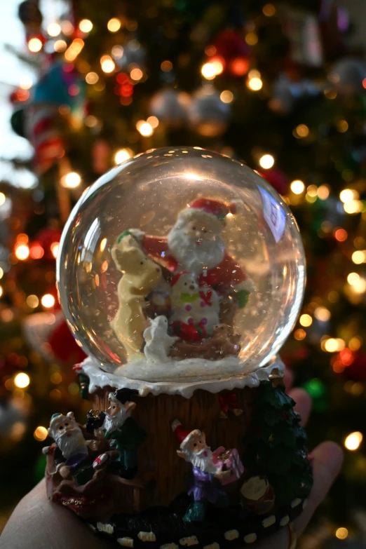 there is a santa statue inside of a snow globe