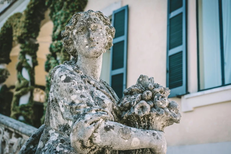 a statue of a woman holding two baby gs