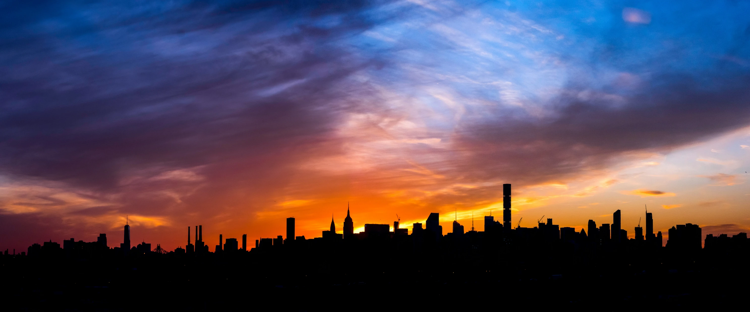 a large city at sunset on a cloudy day