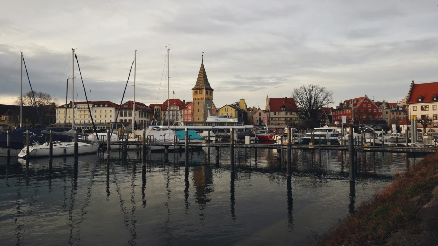 boats are moored on the water in a marina