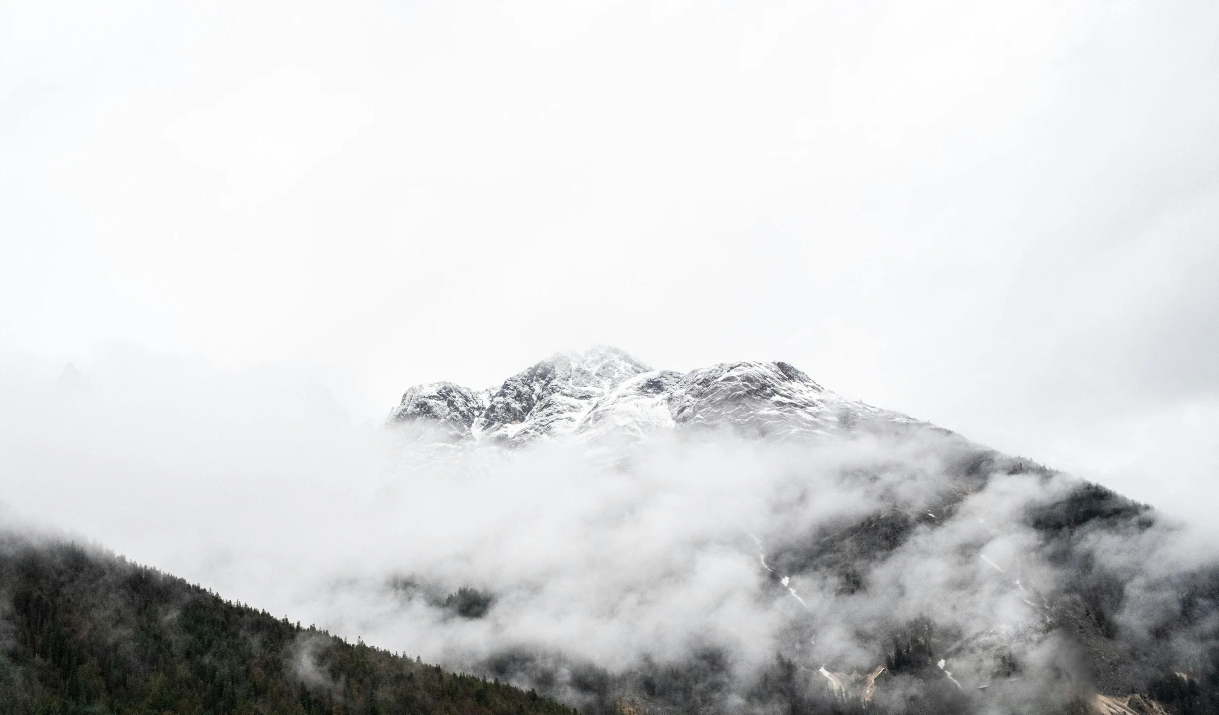 a large mountain with a snow covered peak