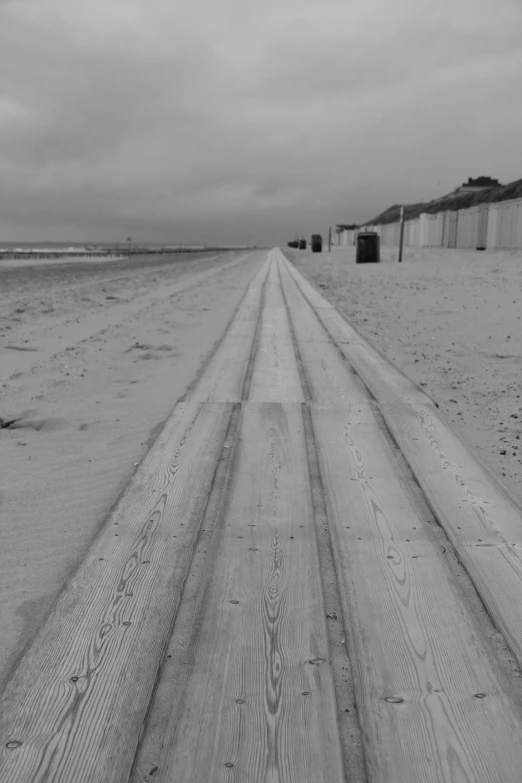 the long tracks lead to the sand where the ocean is almost empty