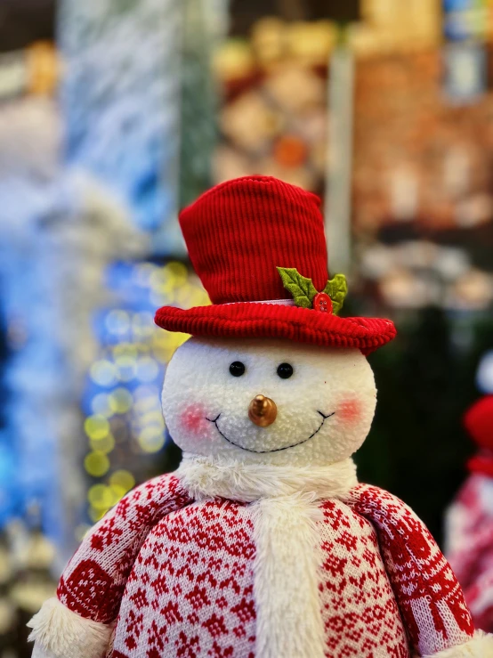 a snowman wearing a red and white scarf and hat