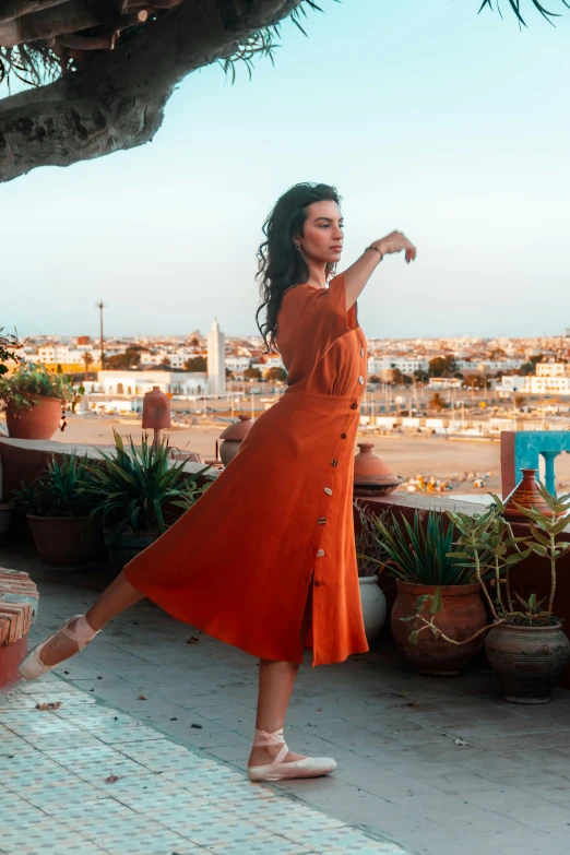 a woman in a orange dress is walking