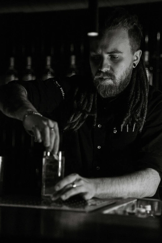 a man at a bar, making a drink