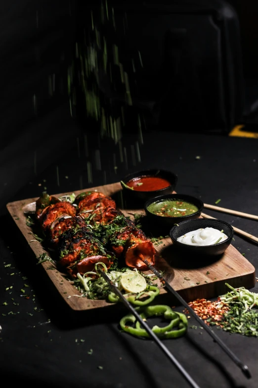 a chopstick,  board and bowls filled with food