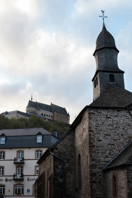 a stone building with a steeple stands against a blue sky