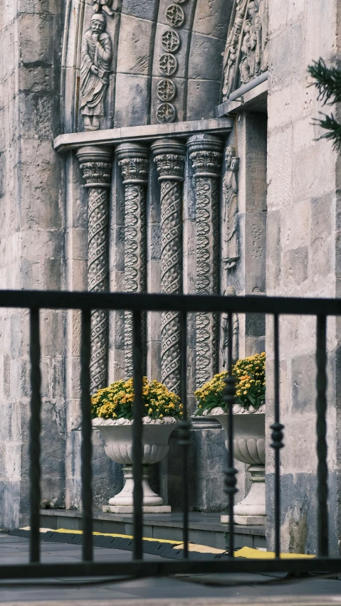 an ornate iron window sill with a planter