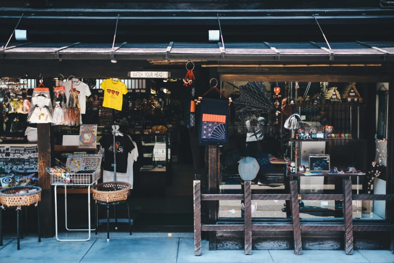 a store front showing various items hanging from a roof